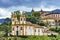 Ancient historical churches among the houses and streets of Ouro Preto city in Minas Gerais