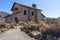 Ancient and historical Small chapel in El Teide, National Park at Tenerife, Canary Islands. Religious woman walking in green dress