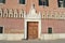 Ancient house with enormous wooden main door at the Italian Venice seafront of the Venice lagoon.