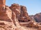 Ancient housing carved in red sand rock in the city of Petra, Jordan