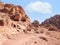 Ancient housing carved in red sand rock in the city of Petra, Jordan