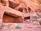 Ancient housing carved in red sand rock in the city of Petra, Jordan. Detail with Tomb of `Unayshu