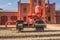 Ancient industrial steam machine displayed outside old factory