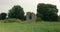 Ancient Irish Christian Round Tower framed by trees