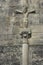 Ancient Jesus Christ sculpture on stone cross. Medieval architecture concept. Faith and suffering symbol. Religion background.