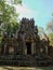 Ancient Khmer Empire stone structure nestled within a forest in Cambodia