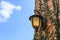 Ancient lantern on wall with blue sky