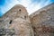 Ancient limestone fortress under a cloudy sky