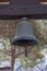 Ancient Little Bronze Bell Hanged on Wooden Crossbeam
