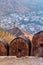 Ancient long wall with towers around Amber Fort and view of Amber village at morning. Rajasthan. India