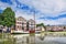 Ancient mansion with a white moored boat mirrored in a canal, Gouda, Netherlands