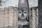 Ancient marvellous stone buddha head statue surrounding by triangle great stone wall at Wat Sri Chum, Sukhothai, Thailand