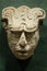 Ancient mayan head with a glyph engraved on front
