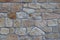 Ancient medieval stone masonry. Texture of a fragment of a wall of an old structure. A background for design and creative work. De