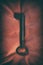 Ancient medieval wrought iron key on red background