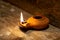 Ancient Middle Eastern oil lamp made in clay on wood table