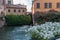 Ancient mill on Sile River with rose garden in centre of Treviso, Italy