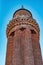 Ancient minaret with loudspeakers against the sky