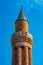 Ancient minaret with loudspeakers against the sky