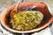 Ancient Minoan food delicacies. Cooking snails in a clay cookware pot over a wood fire in rural Crete.