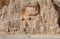 Ancient monuments of Iran and traveler walking past reliefs of Naqsh-e Rustam. Historical necropolis near Persepolis