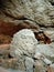 Ancient mountain cave with stalactites, stalagmites, long underground river in white and red stones with petroglyph