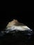 Ancient mountain cave with stalactites, stalagmites, long underground river in white and red stones with petroglyph