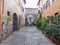 Ancient narrow street with votive niche deep down in the Trastevere distrct to Rome in Italie.