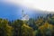 Ancient Neuschwanstein castle on a hill among the autumn forest in the morning sunlight