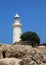 The ancient Odeon Amphitheatre with the lighthouse on the background. Paphos, Cyprus.