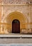 Ancient ornate wooden door of a church in Spain.