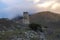 Ancient Ossetian battle tower against a foggy sunset. Verhniy Fiagdon. Northern Ossetia