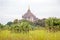 Ancient pagoda in burmese landscape in Bagan