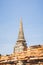 An ancient pagoda in an old temple and a very old brick wall in Ayutthaya, Thailand