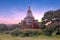 Ancient pagodas in the countryside from Bagan in Myanmar at sunset