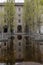 The ancient Palazzo della Pilotta reflected in the water in the historic center of Parma, Italy