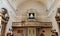 ancient pipe organ with wooden stage painted on the apse of a church and main door