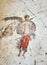 Ancient Pompei fresco of a winged soldier with spear and shield