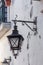 Ancient Portuguese street lights. On walls of houses.