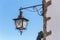 Ancient Portuguese street lights. On walls of houses.