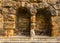 Ancient powerful stone wall with two windows of Middle Ages