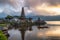 Ancient Pura Ulun Danu Bratan temple with tourist paddle and sun