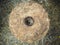 The ancient quern stone hand mill. Old grinding stones straw around. Top view