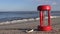 Ancient red broken hourglass sandglass clock on sea beach sand
