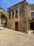 Ancient restored building facade with arch terrace in a Mediterranean townscape in Girona, Catalonia