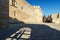 Ancient Rhodes castle with main square. look a shadow from the fence and the person standing in it