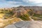 An ancient river bed runs through the eroded, yellow hills of Badlands National Park.