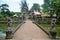 Ancient roadbridge crossing canal go to entrance to inner of Pura Taman Ayun or Mengwi Temple archaeological site for travelers