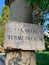 Ancient roman stone column with street name sign in Rome