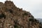 Ancient ruin of stone city in highlands in Dagestan, details of abandoned buildings on majestic mountains landscape in summer.